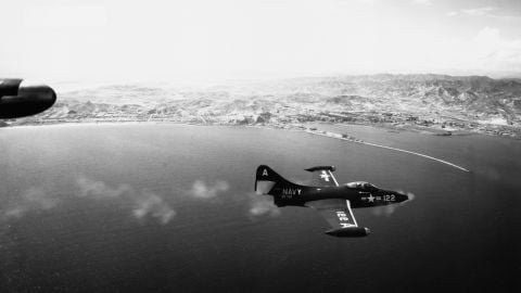 A Grumman F9F Panther fighter jet fires its guns during an attack on the North Korean port of Hungnam in 1951.