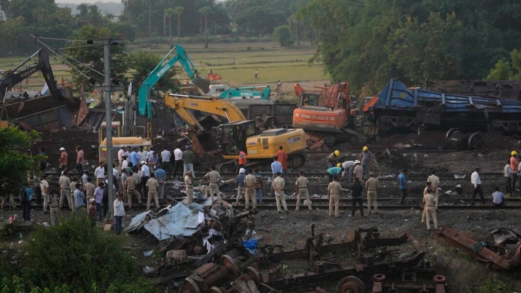 Policemen stand guard at the site of the crash in Balasore on Sunday.