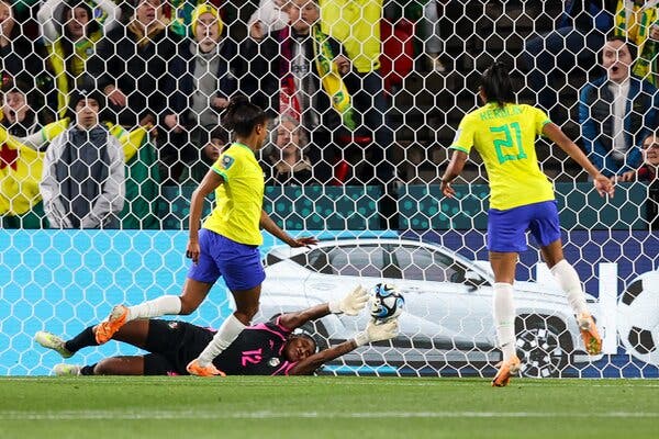 Ary Borges of Brazil scoring a goal past the diving Panama goaltender, Yenith Bailey.