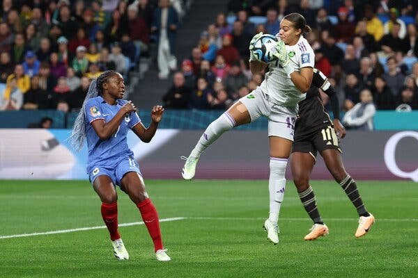 Jamaica goalkeeper Rebecca Spencer, right, saved the ball in front of France’s forward Kadidiatou Diani during their match in Sydney on Sunday.