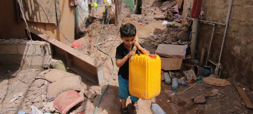 A boy is photographed carrying a water container in the Ala’amaseer area of the city of Aden, Yemen, on 29 April 2020.