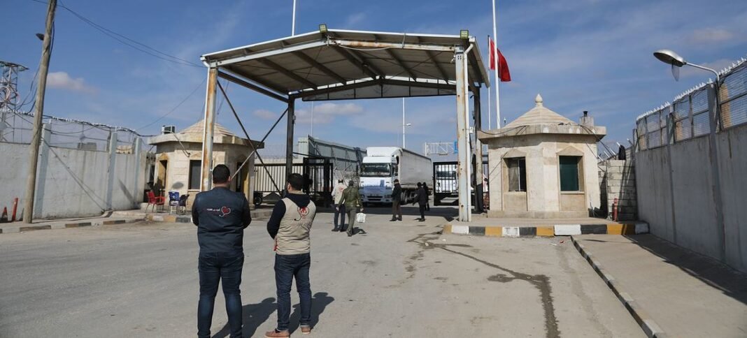  Trucks carrying essential humanitarian supplies travel from Türkiye through the Bab al-Salam border crossing, into northwest Syria.