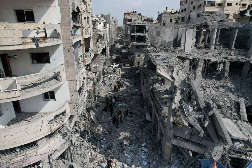 Palestinians look for survivors after an Israeli airstrike in Deir al-Balah, Gaza, on Sunday.