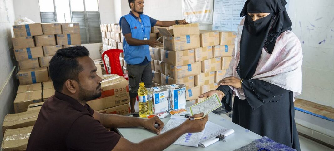 A Rohingya refugee from Myanmar receives support from the UN in Bhasan Char in Bangladesh.