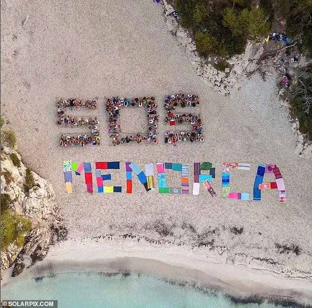 Hundreds of protestors have impeded tourist access to a picture-postcard Menorcan beach called Cala Turqueta