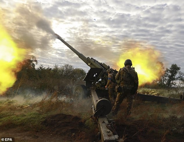 Conflict: Ukrainian troops fire a cannon towards Russian territory in the Kharkiv region
